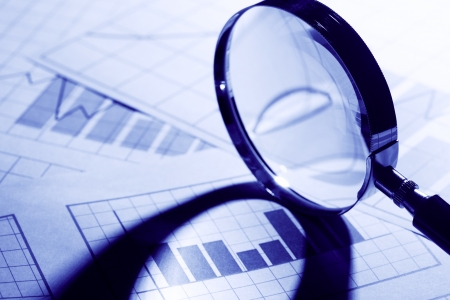 Business concept. Magnifying glass on paper background with chartの写真素材