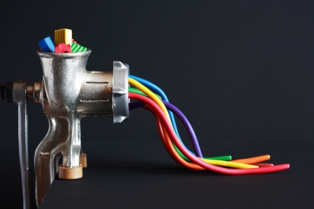 Creation concept. Color plasticine ejected from old mincing machine on dark backgroundの写真素材