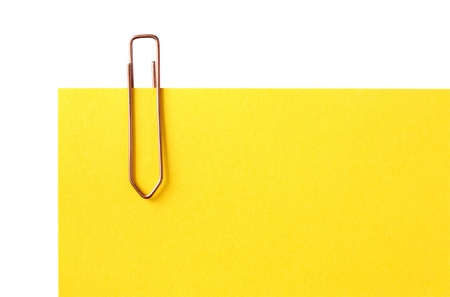 Yellow blank paper sheet with metal clip. Isolated with clipping pathの写真素材