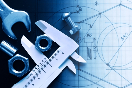 Closeup of work tools and ruler on graph paper with draft