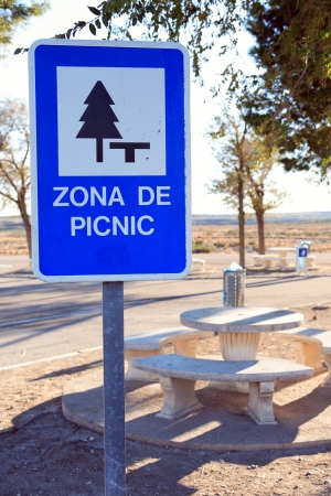 Roar sign Picnic Zone near table on background with roadの写真素材