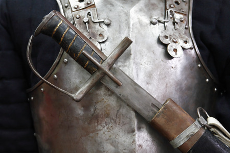 Ancient saber closeup on metal armour background