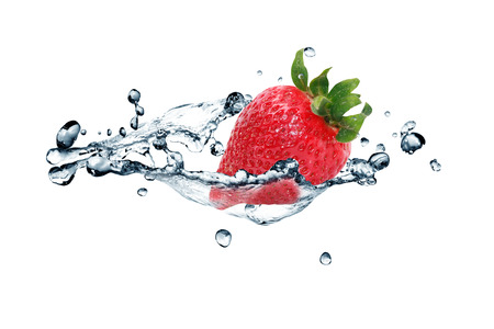 Red strawberry fruit in flowing water on white の写真素材