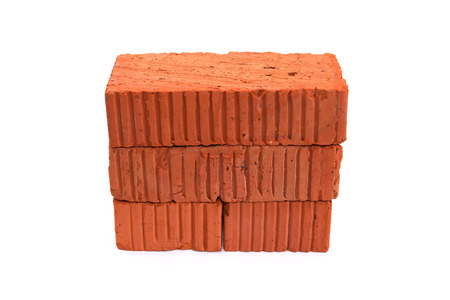 Stack of few red bricks on white background