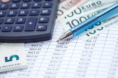 European Union Currency near calculator and pen on paper background with digits tableの写真素材