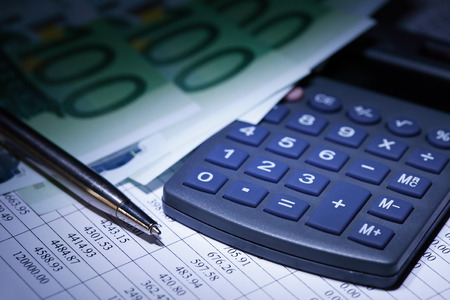 European Union Currency near calculator and pen on paper background with digits tableの写真素材