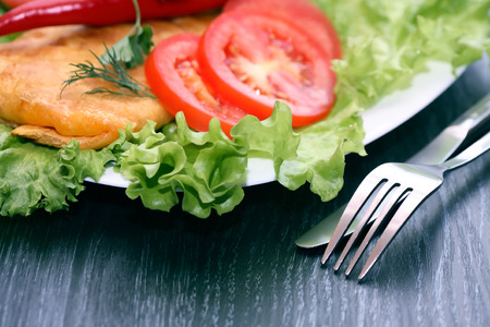Closeup of Mexican tortilla with vegetables near fork and knifeの写真素材