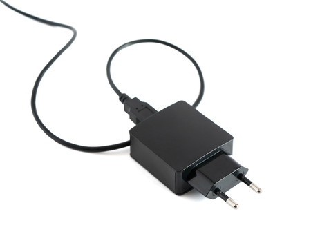 Black adapter plug with cable on white background