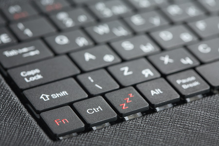 Technology background. Closeup of new black laptop keyboard