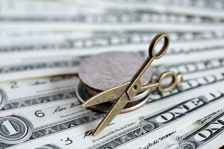 Inflation concept. Small scissors on USA cash backgroundの写真素材