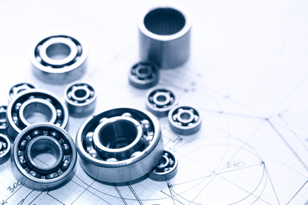 Industrial concept. Few ball bearings on graph paper backgroundの写真素材
