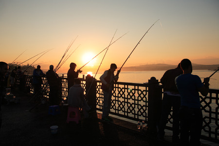 Istanbul, Turkey - July 5, 2015: People fishing at dawn on Galata Bridge in Istanbulのeditorial素材