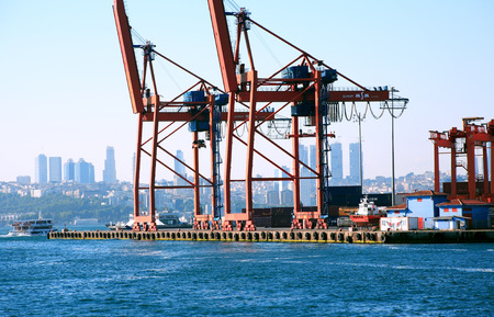 Istanbul, Turkey  July 7, 2015: Panorama with blue sky, sea and container harbour. Closeup of few red cranesのeditorial素材
