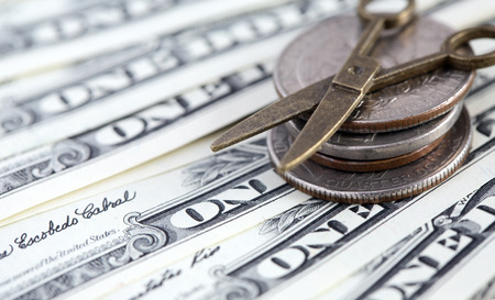 Inflation concept. Small scissors on USA cash backgroundの写真素材