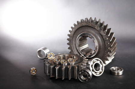 Machinery concept. Abstract composition with few ball bearings near big gears