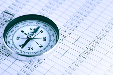 Business concept. Closeup of compass on paper list with digitsの写真素材