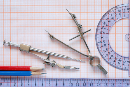 Set of drawing instrument and rulers on graph paper
