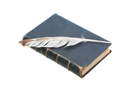 Literature concept. Quill pen on old book on white backgroundの写真素材