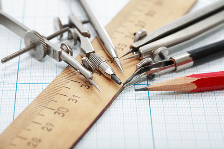 Set of vintage drawing instrument and ruler on graph paper