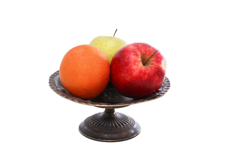 Two apples and orange in nice metal vintage fruit bowlの写真素材