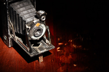 Closeup of old film camera on nice wooden backgroundの写真素材
