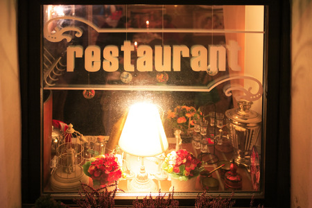 Russian restaurant window with lighting lamp at night