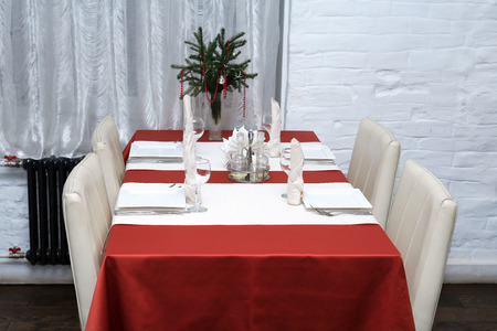 Empty table for four and chairs against white wall in restaurantの写真素材