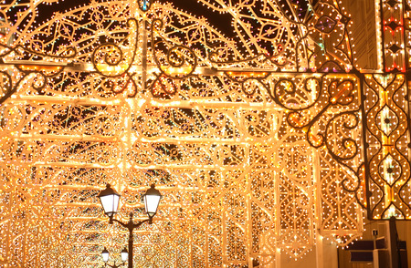 Street lamp on nice background with holiday illumination in night cityの写真素材