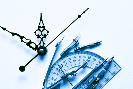Set of drawing instrument and ruler near clock faceの写真素材