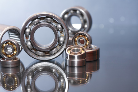 Few ball bearings on glass surface with reflectionの写真素材