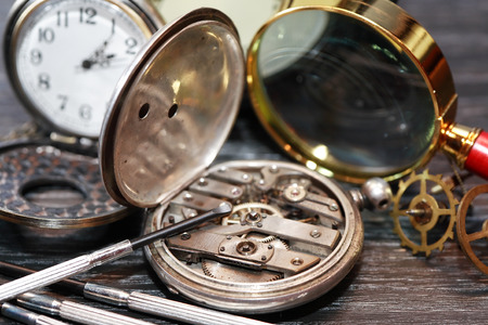 Vintage still life with ancient silver pocket watch