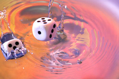 Dice cubes falling in vivid water with splash