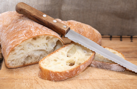 Freshness sliced bread near knife on wooden boardの写真素材