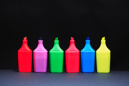 Set of color markers in a row on dark background