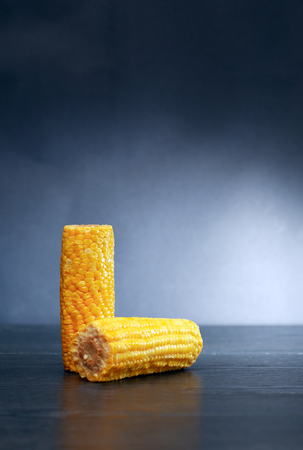 Cooking concept. Corn cobs against nice dark backgroundの写真素材