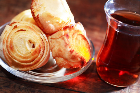 Cup of  oriental tea near pastry on wooden backgroundの写真素材
