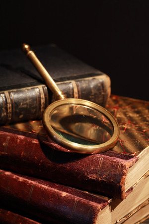 Vintage library. Closeup of magnifying glass on old bookの写真素材