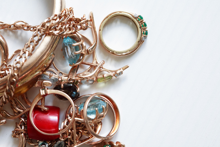 Set of various jewelry adornments on white wooden background with free spaceの写真素材