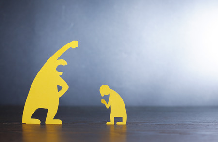 Big screaming man against small miserable man made from yellow paperの写真素材