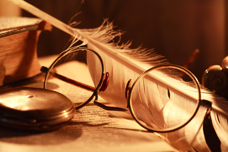 Vintage still life with lighting candle near old thingsの写真素材