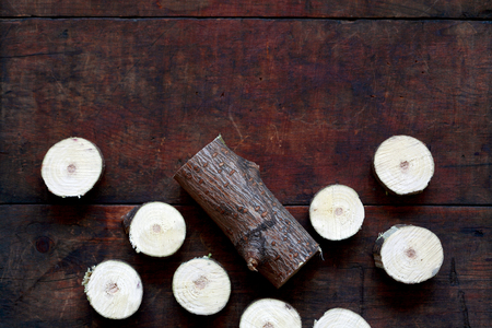 Few small logs from sawn tree on wooden backgroundの写真素材