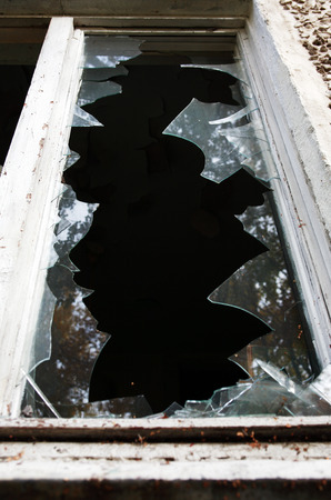 Eviction concept. Old abandoned building with shattered windowsの写真素材