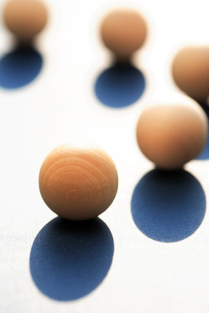 Abstract composition with few small wooden balls on light backgroundの写真素材