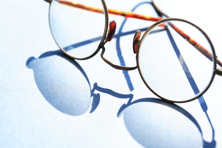 Old spectacles with shadow against sun lightの写真素材