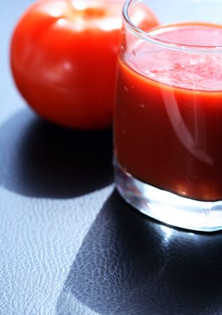 Full glass of tomato juice near freshness tomatoの写真素材