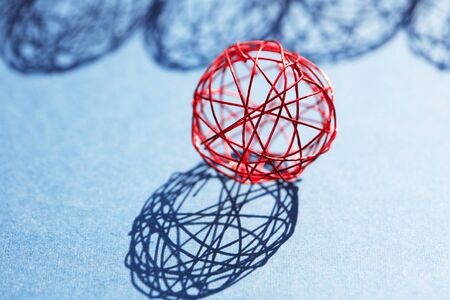 Set of red balls made from wire in a row against sun lightの写真素材
