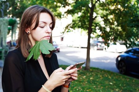 The girl sends a message from her smartphoneの写真素材