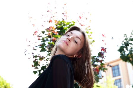 Beauty young woman against white background with treeの写真素材