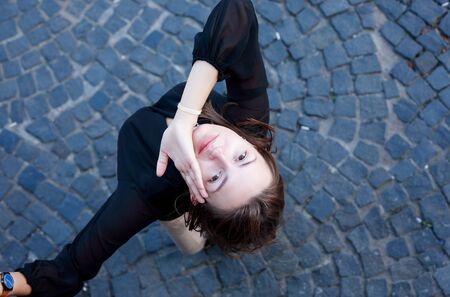 Beauty young woman against nice gray pavement backgroundの写真素材