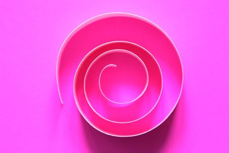 One purple spiral made from paper on pink backgroundの写真素材